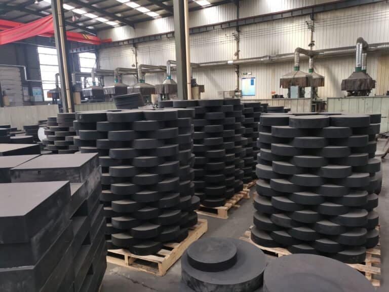 Laminated bearing in Hebei Guchen factory – steel reinforced rubber bearings stacked in workshop